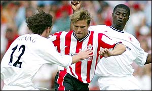 Anders Svensson tries to find a way through Jonathan Greening (left) and George Boateng (right)