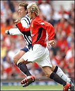 West Brom's Sean Gregan takes on David Beckham of Manchester United