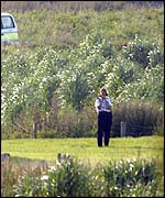 Police officer searching area near Brandon in Suffolk