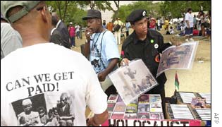 Members of the New Black Panther Party sell prints of early 20th century lynchings at the rally