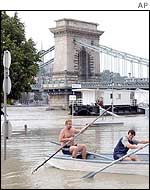 People use a rowboat after the Danube flooded its banks in Budapest