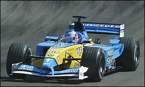 Button makes an error by putting his rear wheel onto the grass, and spins out of the race. 