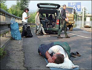 Czech rescue worker sleeps near the German border (AP)