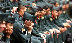 Colombian soldiers await the beginning of a ceremony