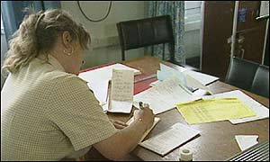 A nurse signs a patient's prescription