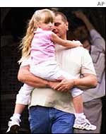 Father holds child close in Soham