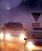 An ambulance carries the bodies to a hospital in Cambridge