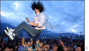 A fan thrown skywards by the crowd