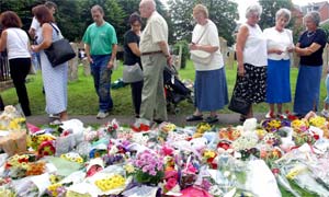 People lay flowers and pray at St Andrew's Church, Soham