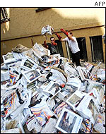 Voluntary workers throw out tourist guides in front of the synagogue in Prague's Old Town 