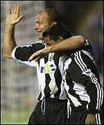 Newcastle striker Alan Shearer celebrates scoring with Nolberto Solano