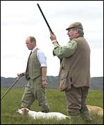 Barry Wilcox raises his shotgun