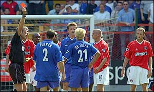 Paul Konchesky (second right) is sent off for a challenge on Enrique de Lucas