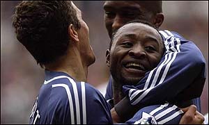 Lomano LuaLua celebrates his first goal for newcastle against derby with team-mates Laurent Robert and Sylvain Distin