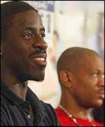 Dwain Chambers sits next to Maurice Greene at a pres conference