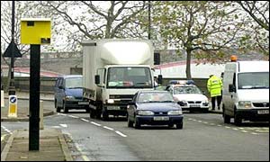 Yellow speed camera on a busy road