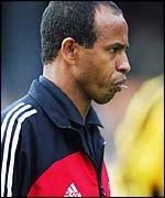 Jean Tigana chews on a toothpick