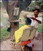 An Asian barber under a tree