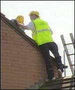 Repair work is carried out on damaged roofs