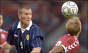 Scotland's Kevin Kyle heads the ball past Denmark's Rene Henriksen