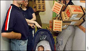 An Israeli family wait to pick up gas masks provided by the army