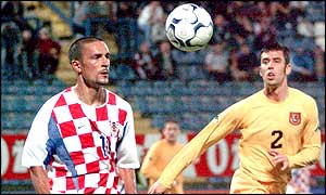 Tomislav Maric (left) and Wales' Mark Delaney run for possession of the ball during the 1-1 draw in Croatia