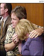 Damon (l) and Brenda van Dam comfort each other after the guilty verdict