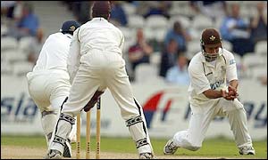 Surrey skipper Adam Hollioake sends opposite number Robin Smith back to the pavilion