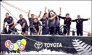 Team members of the Black Magic boat celebrate their win in the 2000 America's Cup