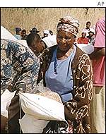 A woman collects US donated food in Zimbabwe