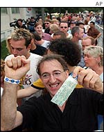 Jubilant fans clutch tickets and wristbands