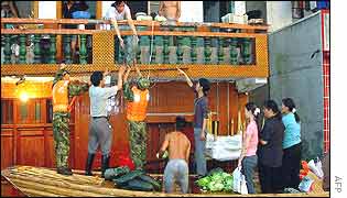 Soldiers evacuate a family