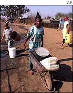 People fetch drinking water in squatter suburb of Kliptown, Johannesburg
