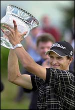Adm Scott holds the trophy aloft