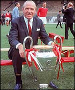 Manchester United manager Matt Busby displays the European Cup