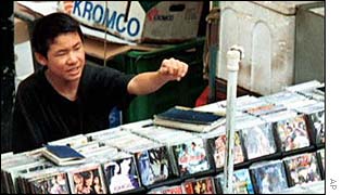 Pavement vendor selling pirated CDs in Kuala Lumpur