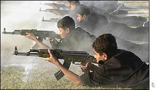Iraqi schoolboys practice firing assault rifles