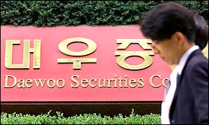 A South Korean pedestrian passes by a Daewoo Seurities branch in Seoul on Monday 