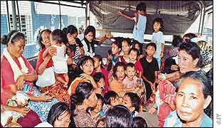 Illegal Philippine immigrants squatting inside a police truck as they are deported from Sabah, Malaysia