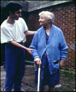 A blind woman with her carer