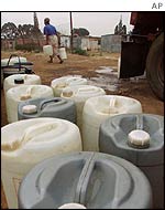 Residents of a Johannesburg township pile up water supplies