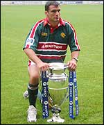 Martin Johnson poses with the Zurich Premiership trophy on the pitch at Twickenham