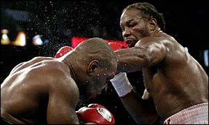 Lennox Lewis (right) hands out the punishment to Mike Tyson
