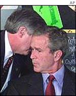 An aide tells President Bush that a second plane has hit the World Trade Center