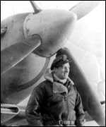 RAF fighter pilot standing in front of his Spitfire