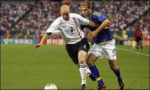 England's Danny Mills holds off Sweden's Teddy Lucic