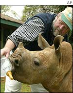 Fred O'Regan bottle-feeds a four-month-old White Rhinoceros