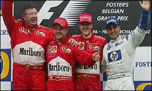 Ferrari chief Ross Brawn celebrates woth Rubens Barrichello and Michael Schumacher