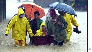A woman being rescued from the floods