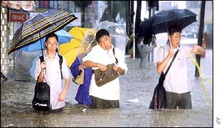 Youths wade through the floods
